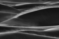 The curves of the sand dunes and the haze of sand dust