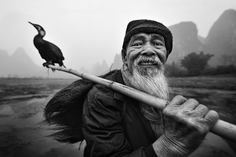 OLD FISHERMAN WITH CORMORANT