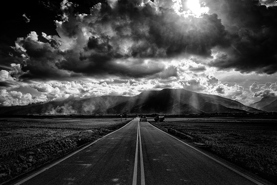 Crepuscular rays on the road