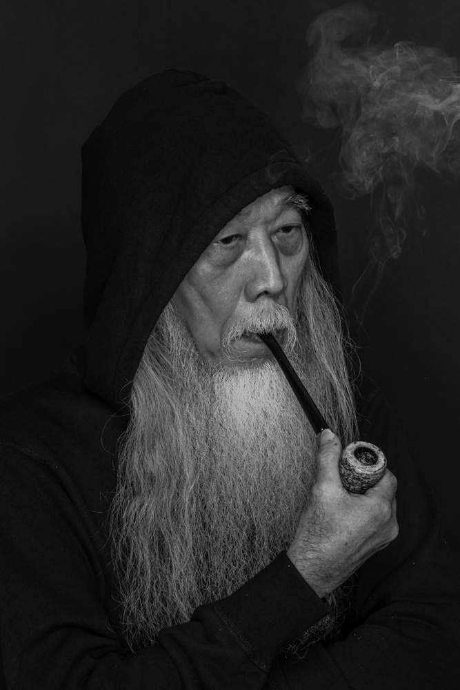 Man With A Long Beard Smoking A Pipe
