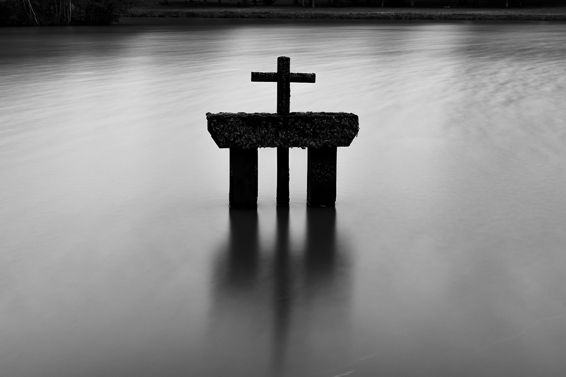 Wooden cross in the water